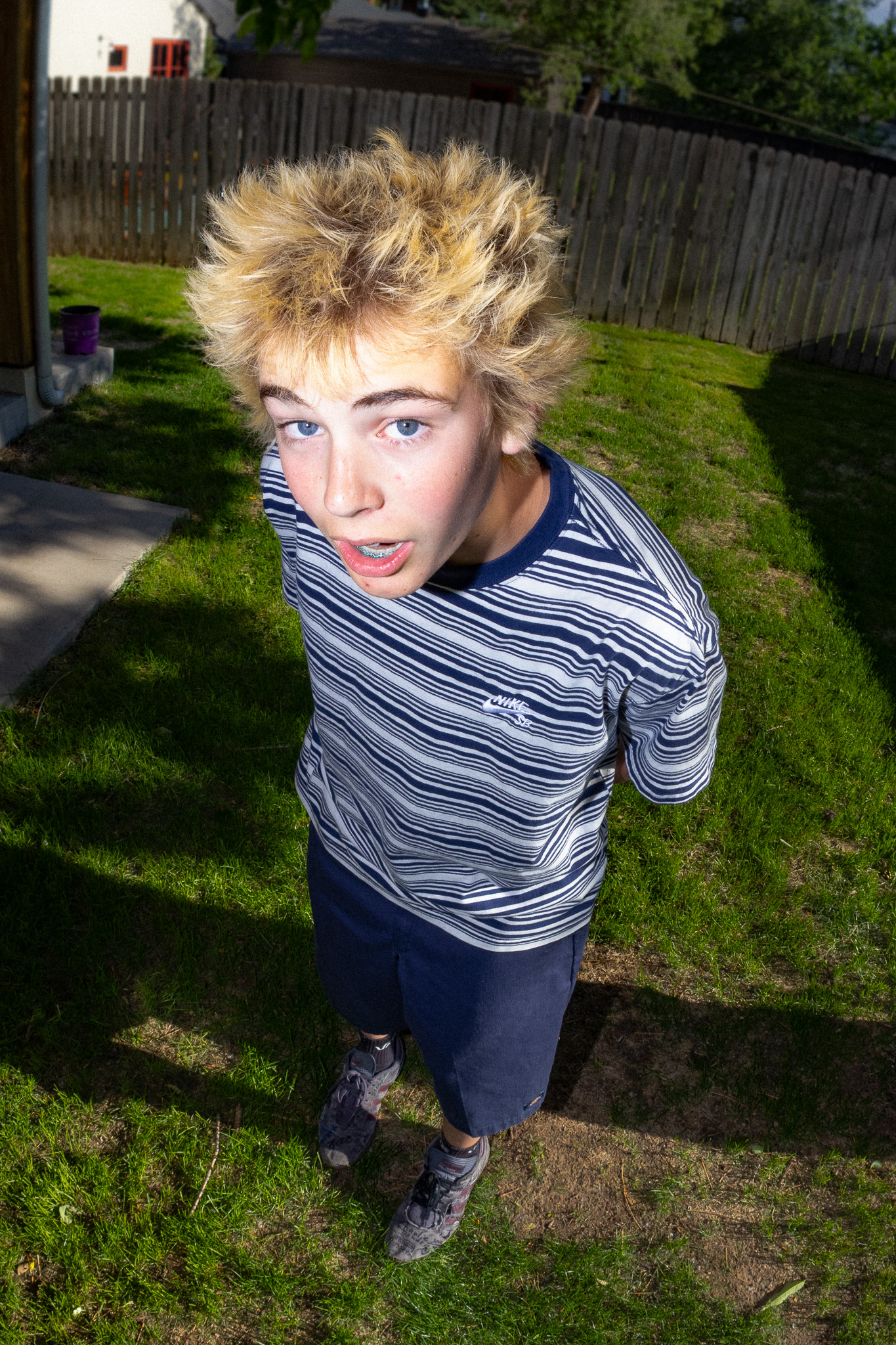 Blond model in a striped shirt photographed from above in grayscale
