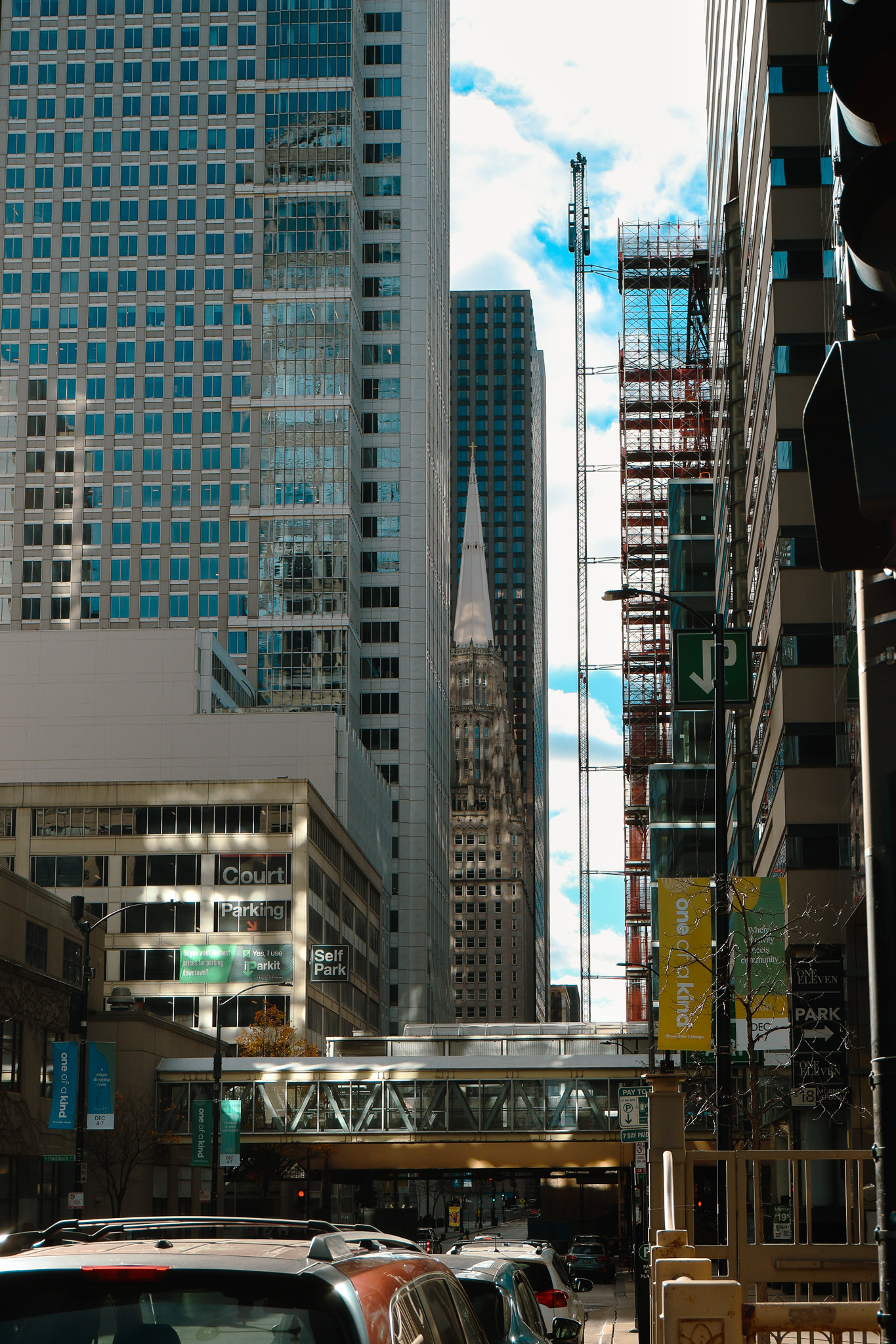 Downtown street framed by high-rise buildings in grayscale